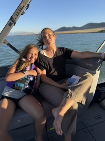 Family on the boat at sunset